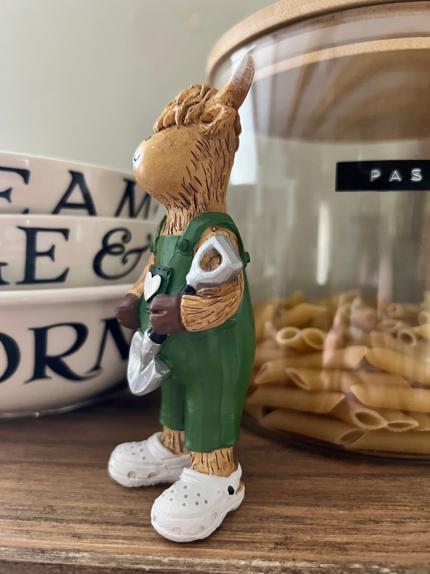 Highland Cow Holding Shovel