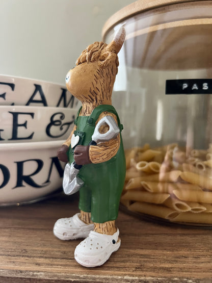 Highland Cow Holding Shovel