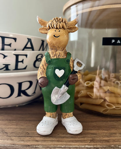 Highland Cow Holding Shovel
