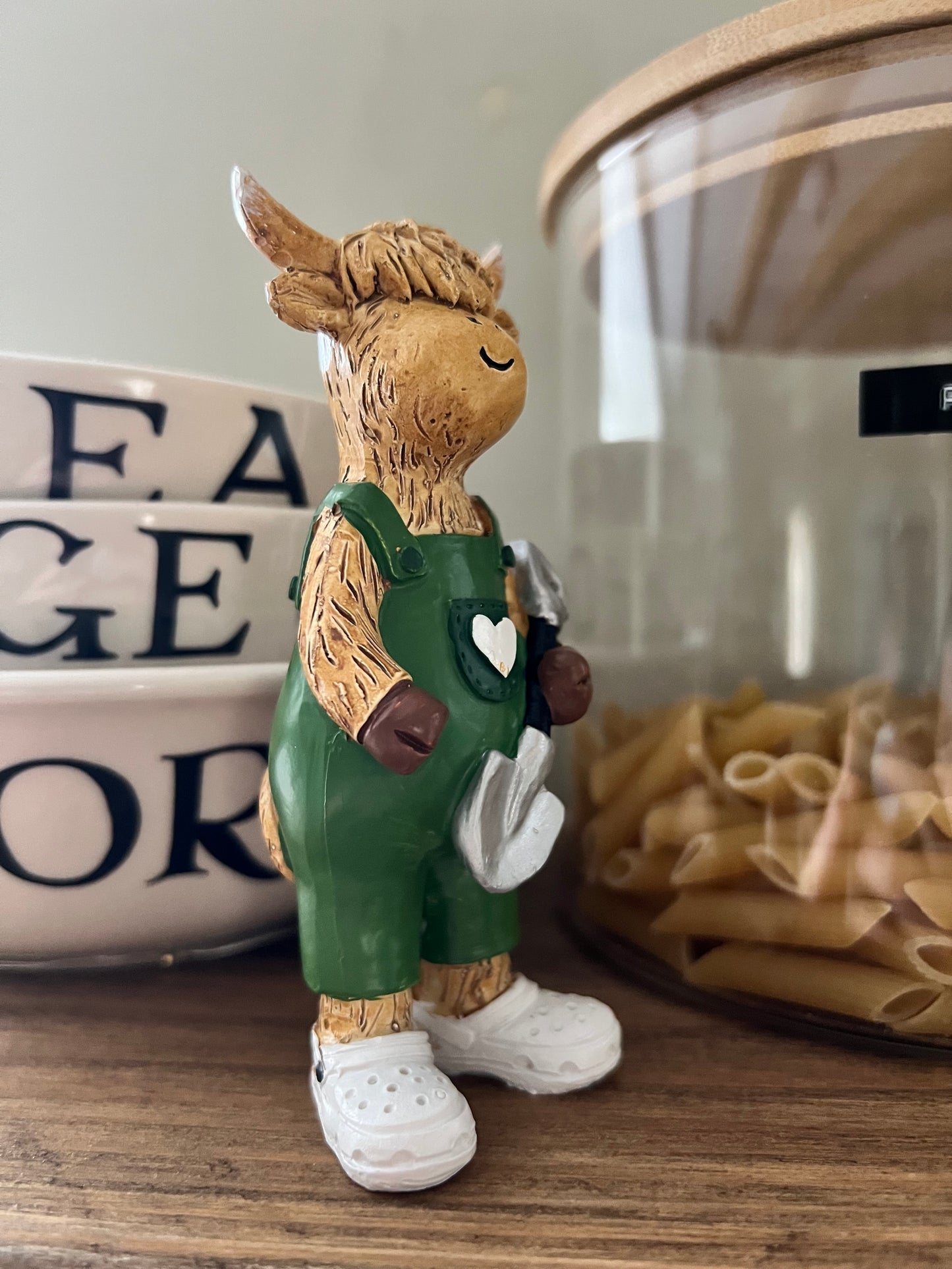 Highland Cow Holding Shovel